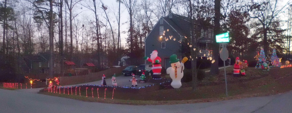 Christmas ligths including Frosty, 12-foot Santa, penguins on snowmobile inflatables, 2 lighted mega trees, and Santa and Mrs. Claus on a swing with their cottage